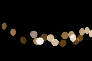 Christmas background .Abstract Christmas lights on black background. Glowing light bulb garland. Copy space