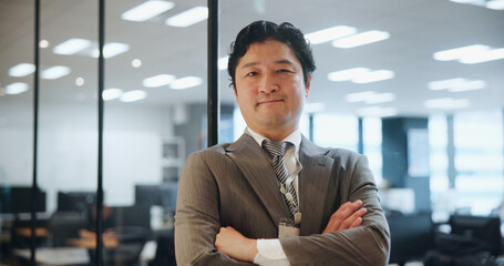 Asian man, portrait and confident in office for business, career development or growth in Japan company. Mature broker, financial advisor or arms crossed in workplace with ambition, pride or about us