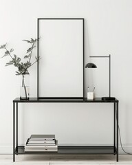 Minimalist home office with a black desk. a lamp. a plant. and a blank poster frame
