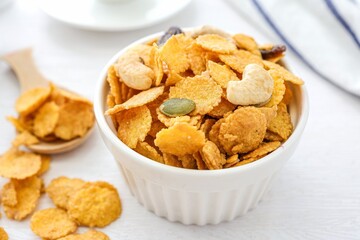 Cornflakes in a white bowl on white background