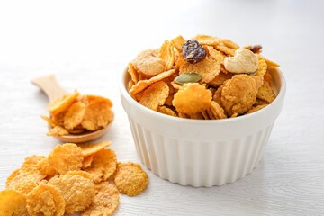 Cornflakes in a white bowl on white background
