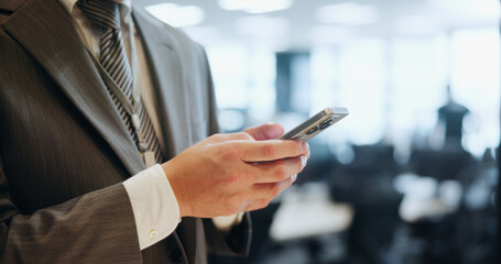 Business, hands and man in office, smartphone and typing with social media, network and texting. Closeup, employee and consultant in workplace, message to contact and cellphone with app and Japan