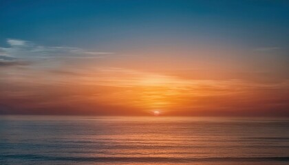 Fototapeta premium Golden Hour Horizon: A breathtaking sunset casts a warm glow over a vast expanse of ocean, painting the sky with vibrant hues of orange, pink, and purple. The sun dips below the horizon.