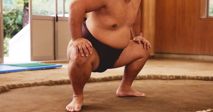 Dohyo, mawashi and legs of Sumo wrestler closeup for martial arts competition or tournament in Japan. Fitness, power and strength with person in arena or ring for culture, heritage or national pride