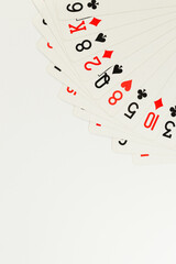 Fototapeta na wymiar Top view of playing cards on white background. Board game, poker. Copy space, flat lay.