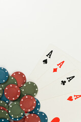 Top view of playing cards, poker chips on white background. Four aces cards, board game, poker. Copy space, flat lay.