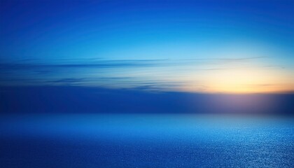Obraz premium Serene Sunset over the Ocean: A breathtaking panorama of a tranquil ocean at sunset, with a vibrant gradient of blue and yellow hues in the sky, evoking a sense of peace and tranquility.