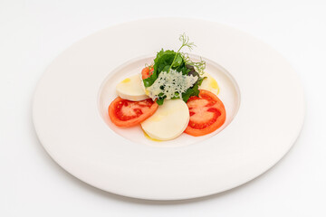 Tomato and mozzarella salad on a white porcelain plate, Caprese Salad