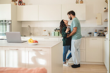 Romantic couple sharing intimate wine moment modern kitchen lifestyle work balance