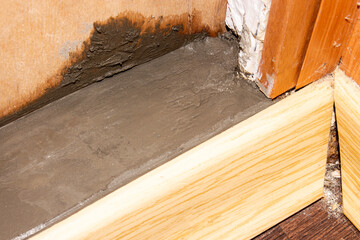 Filling the threshold with concrete.Cementing of the threshold.Renovation of the apartment.Concrete threshold background.