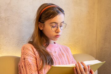 Serious teenage girl reading a book. Emotion concept.