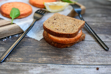  Fishburger.Homemade ketogenic  Salmon Burger with Tartar Sauce and  whole grain ketgenic bread. Healty  low carb high protein food
