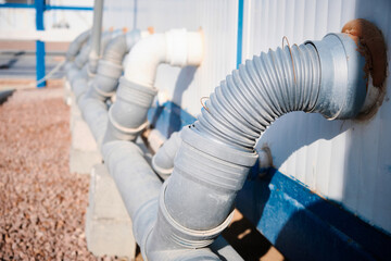 Junction of plastic sewer pipes. Sewage pipeline system of industrial prefabricated building 