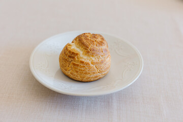 choux cream or cream puff or French profiteroles with fresh cream set on cafe table