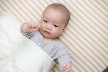 Baby lying down on soft baby bedding