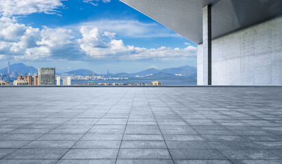 Fototapeta premium Empty square floor with modern city buildings scenery in Shenzhen. car advertising background.