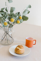 choux cream or cream puff or French profiteroles with fresh cream set on cafe table with antique colored cup
