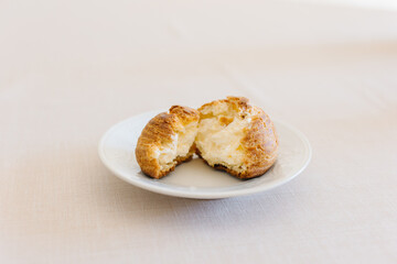 choux cream or cream puff or French profiteroles with fresh cream set on cafe table