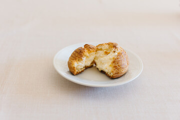 choux cream or cream puff or French profiteroles with fresh cream set on cafe table