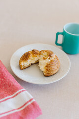 choux cream or cream puff or French profiteroles with fresh cream set on cafe table with antique colored cup