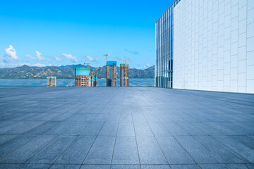 Fototapeta premium Empty square floor with modern city buildings scenery in Shenzhen. car advertising background.