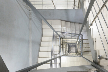 Fototapeta premium Generic square staircase shaft with steel net for fall safety