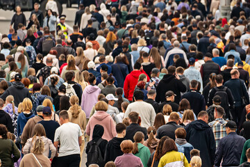 a background of unrecognizable people. Pandemonium in the metropolis. Overpopulation of the modern...