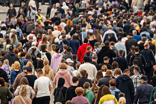 a background of unrecognizable people. Pandemonium in the metropolis. Overpopulation of the modern city. lots of people outside in the open air. A lot of urban residents have a rear view.