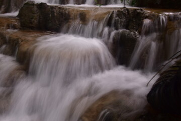 Obraz premium Travel to waterfalls during the rainy season, The tiers of the waterfall contrast beautifully with the sky