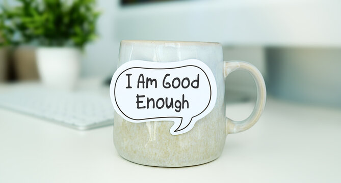 I am good enough is shown using the text. Motivational phrase to love and respect yourself unconditionally, stop seeking others approval