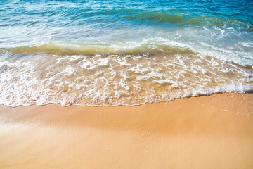 Serene Ocean Waves Gently Caressing Sandy Beach Shoreline in Golden Sunlight