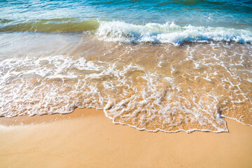 Serene Ocean Waves Gently Caressing Sandy Beach Shoreline in Golden Sunlight
