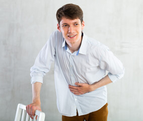 Man experiencing acute abdominal pain