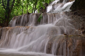 Obraz premium Travel to waterfalls during the rainy season, The tiers of the waterfall contrast beautifully with the sky, Nature itself is the best physician
