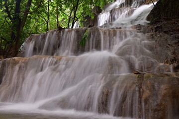 Fototapeta premium Travel to waterfalls during the rainy season, The tiers of the waterfall contrast beautifully with the sky, Nature itself is the best physician