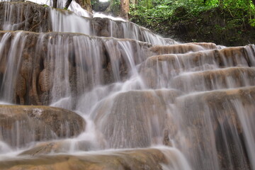 Obraz premium Travel to waterfalls during the rainy season, The tiers of the waterfall contrast beautifully with the sky, Nature itself is the best physician