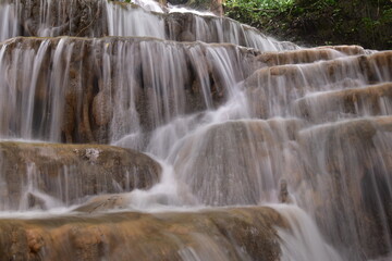 Obraz premium Travel to waterfalls during the rainy season, The tiers of the waterfall contrast beautifully with the sky, Nature itself is the best physician