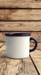 White Enamel Mug with Blue Rim on Rustic Wooden Background