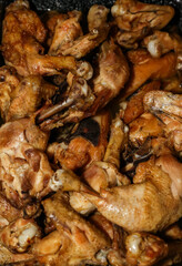 Chicken drumsticks and chicken wings in cauldron. Traditional romanian food