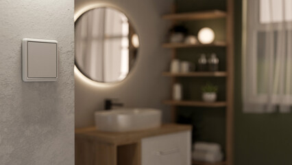 A close-up of a light switch on a white wall, with a blurred modern bathroom in the background.