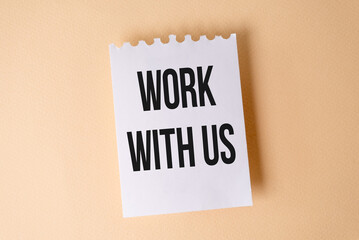 Work With Us Impression text on white sticky note on yellow background.