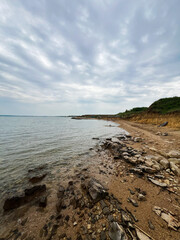 Serene rocky coastline under a moody overcast sky