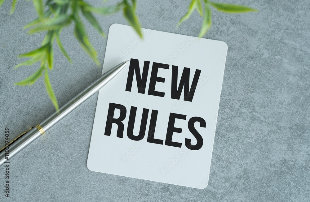 Poster new rules text on the notebook with pen on gray background