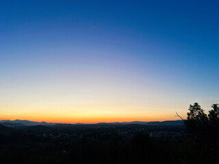 Breathtaking sunset over serene landscape with glowing sky