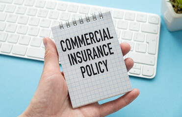 Commercial insurance policy- text label in the contract document on the planning folder. Transfer of risk in business by purchasing.
