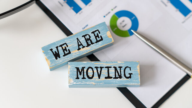 We are moving symbol. Concept word We are moving on wooden blocks. Business and We are moving concept.