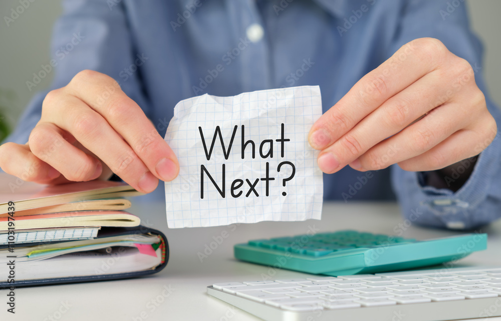 Poster female hand showing what's next? text on paper notepad.