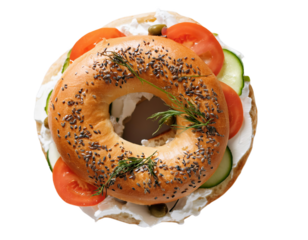 Fresh bagel with cream cheese, vegetables, and dill on transparent background