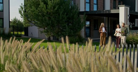 The realtor shows the buyers the house. The family wants to buy a townhouse