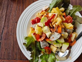 Thai spicy salad with seafood on wooden table, Thai food.